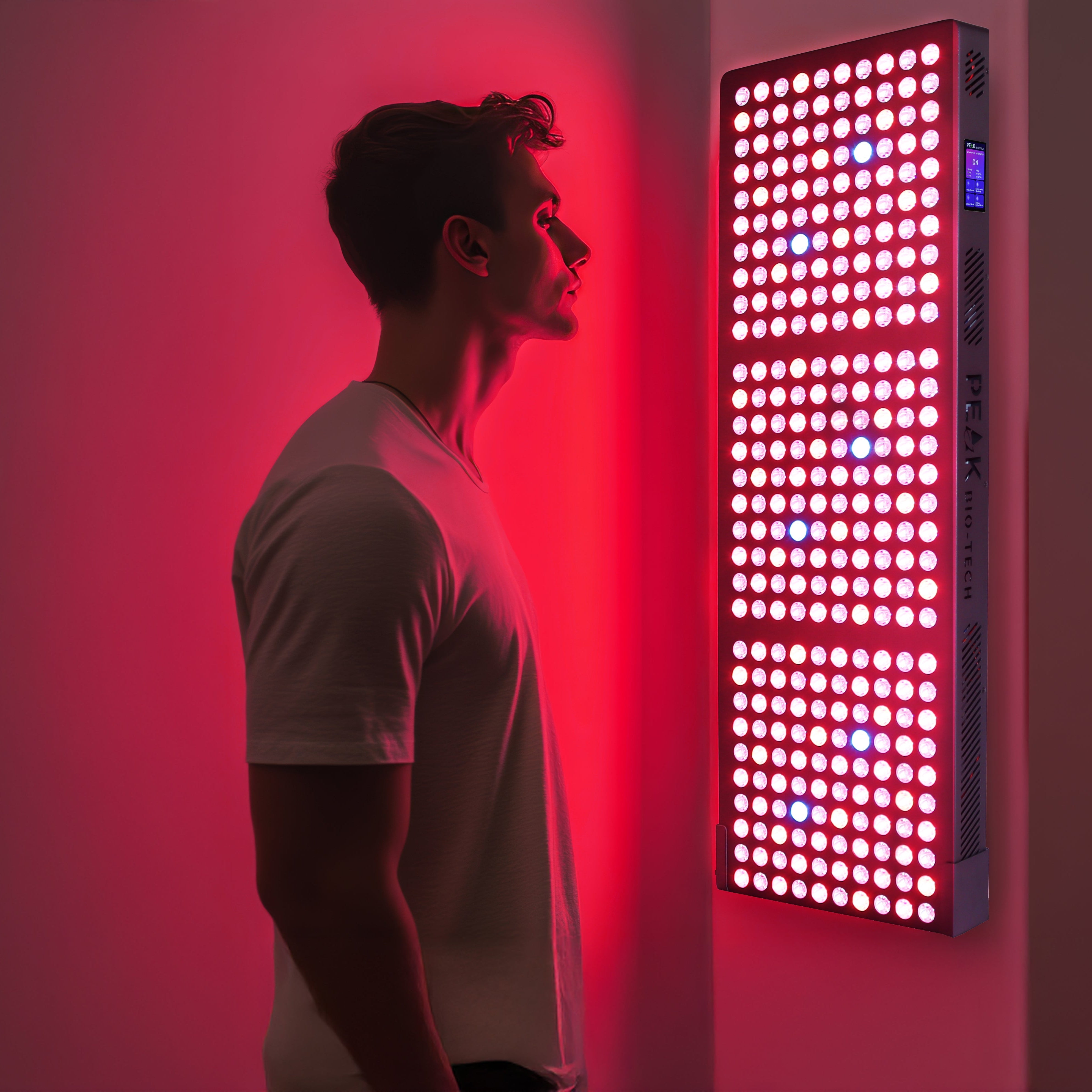 Man standing in front of Peak Radiance Pro 1500W clinical grade Red light therapy panel for mitochondria boost.